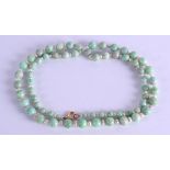 AN EARLY 20TH CENTURY CHINESE CARVED JADEITE AND PEARL NECKLACE. 74 cm long.