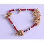 AN EARLY 20TH CENTURY TRIBAL CORAL AND TOOTH BRACELET.