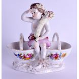 A 19TH CENTURY GERMAN AUGUSTUS REX PORCELAIN DOUBLE SALT formed with a seated boy holding a
