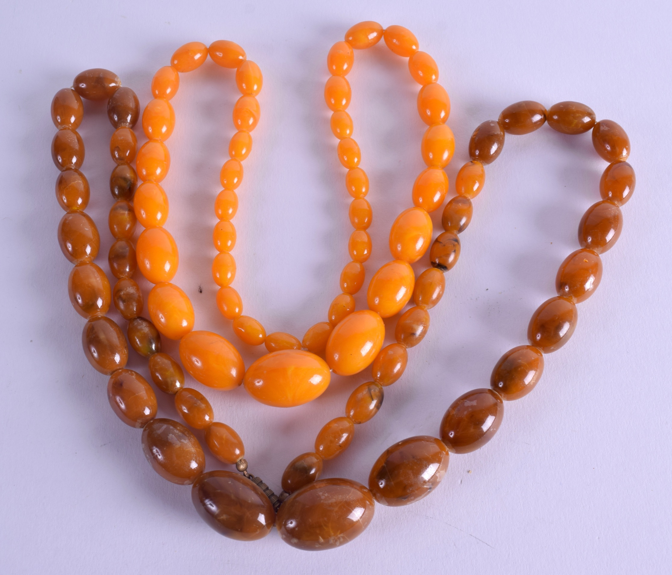 TWO AMBER TYPE NECKLACES. (2)