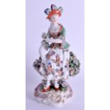 AN 18TH CENTURY DERBY FIGURE OF A DANCING GIRL modelled holding flowers upon a rococo base. 20 cm