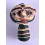 AN UNUSUAL EARLY CONTINENTAL GLASS AMULET in the form of a head. 4 cm x 3 cm.