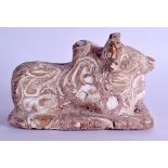 A CHINESE QING DYNASTY MARBLED POTTERY FIGURE OF A RECUMBANT BULL modelled upon a rectangular