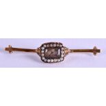 AN EARLY VICTORIAN YELLOW METAL AND SEED PEARL MOURNING BROOCH. 5.5 cm wide.