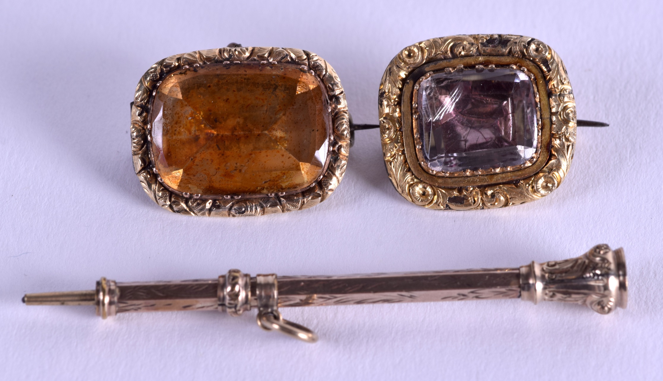 A VICTORIAN GOLD PROPELLING PENCIL together with two brooches. (3)