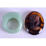 AN EARLY 20TH CENTURY CHINESE CARVED JADEITE RING together with a C1900 glass cameo. (2)