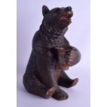 A LARGE 19TH CENTURY BAVARIAN BLACK FOREST MUSICAL TOBACCO JAR in the form of a seated brown bear.