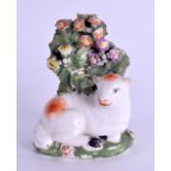 AN 18TH CENTURY DERBY FIGURE OF A LAMB modelled behind a flowering tree. 7.5 cm x 5.5 cm.