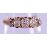 AN ANTIQUE 18CT GOLD FIVE STONE DIAMOND RING of approx 0.75 cts. Size N.