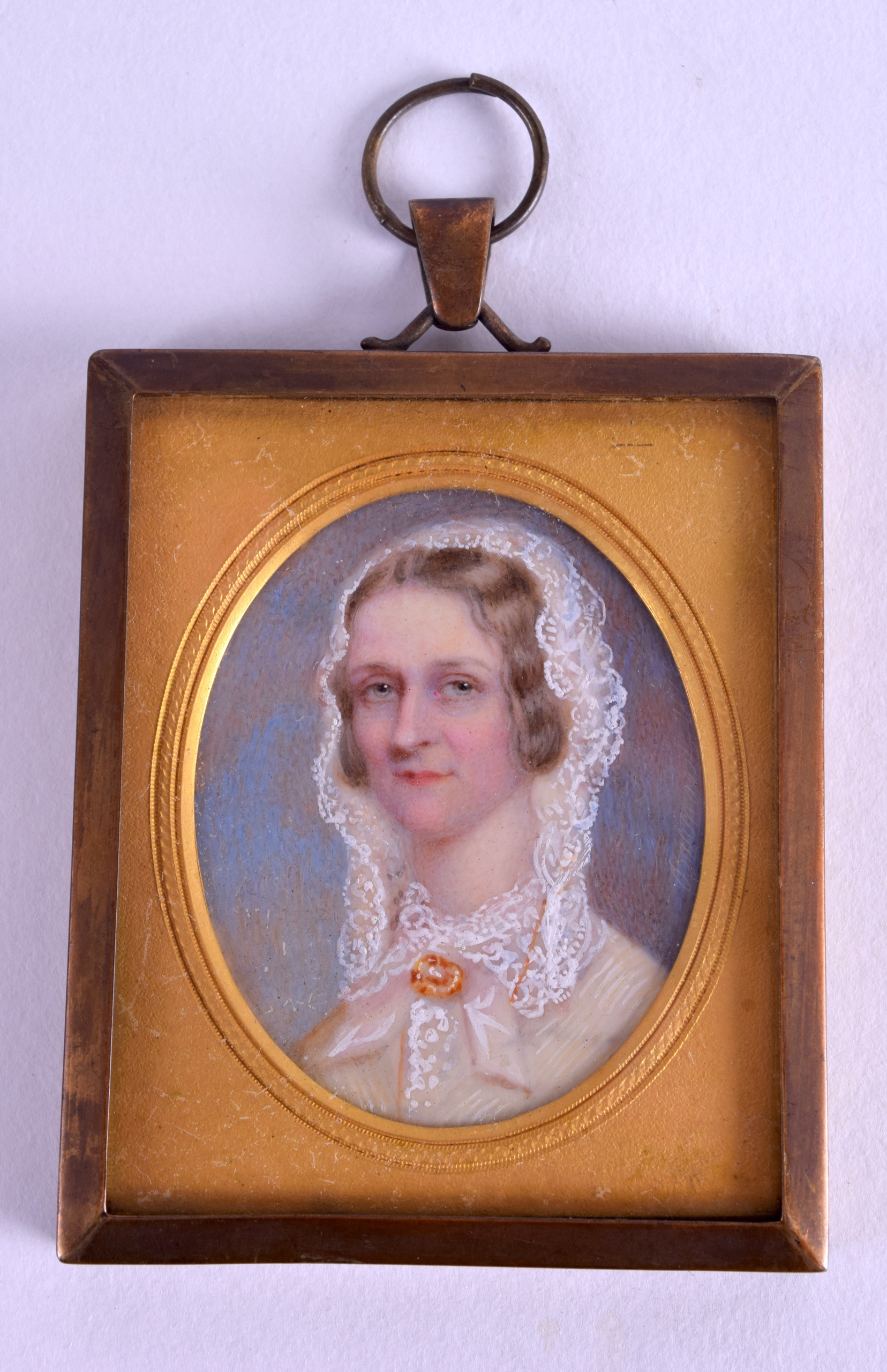 AN EARLY VICTORIAN PAINTED IVORY PORTRAIT MINIATURE depicting a female wearing white head dress.