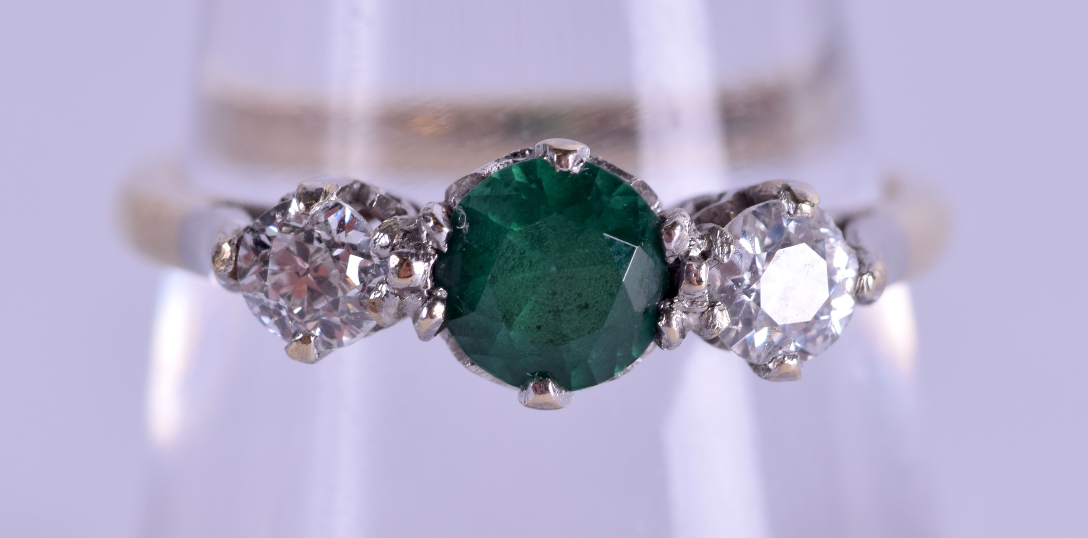 A 9CT GOLD EMERALD AND DIAMOND RING of approx 0.4 cts. 2.6 grams. Size O.