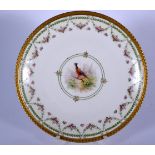 AN EARLY 20TH CENTURY FRENCH LIMOGES PORCELAIN DISH, decorated with a pheasant and floral border. 22