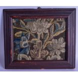 A 17TH CENTURY VERDURE TAPESTRY FRAGMENT depicting blue flowers on a brown ground. 18 cm x 23 cm.