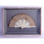 A FRAMED 19TH CENTURY EUROPEAN CARVED IVORY AND SILK FAN decorated with foliage. Fan 37 cm wide.