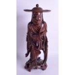 A 19TH CENTURY CHINESE CARVED ROOTWOOD FIGURE OF A STANDING MALE modelled holding prayer beads. 40 c