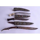 THREE UNUSUAL 19TH CENTURY MIDDLE EASTERN TRIBAL JEWELLED DAGGERS inset with turquoise, coral etc. L