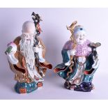 A LARGE PAIR OF 1950S CHINESE PORCELAIN FIGURES OF A MALE AND FEMALE each modelled holding sceptres.