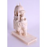 A 19TH CENTURY INDIAN CARVED IVORY ELEPHANT modelled with attendants. 9.5 cm x 10.5 cm.