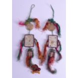 A RARE PAIR OF LATE 19TH CENTURY CHINESE HANGING SILK COURT PENDANTS with attached jade pendants. 30