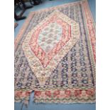 AN ANTIQUE PERSIAN SENNEH KILIM RUG, decorated with motifs. 285 cm x 183 cm.