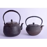 TWO 19TH CENTURY JAPANESE MEIJI PERIOD IRON TETSUBIN TEAPOTS AND COVERS. 16 cm & 14 cm wide. (2)