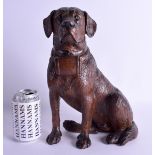 A LARGE 19TH CENTURY BAVARIAN BLACK FOREST FIGURE OF A HOUND modelled seated with a basket around hi