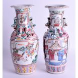 A PAIR OF 19TH CENTURY CHINESE CANTON FAMILLE ROSE VASES painted with figures and chilong dragons. 2