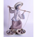 A LLADRO FIGURE OF AN ORIENTAL LADY modelled carrying scales overlaid with fish. 26 cm x 18 cm.