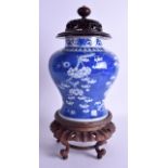 A 19TH CENTURY CHINESE BLUE AND WHITE VASE AND COVER bearing Kangxi marks to base, painted with prun