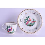 AN 18TH CENTURY WORCESTER COFFEE CUP AND SAUCER of faceted form, painted with exotic birds in a leaf