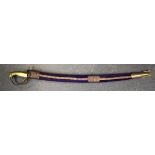 A MID 20TH CENTURY INDIAN SABRE OR SABRE SWORD, formed with beast handle and velvet scabbard. 81 cm