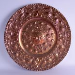 AN UNUSUAL LARGE SOUTH AMERICAN COPPER AZTEC CHARGER decorated with motifs and mask heads. 61 cm wid