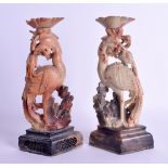 A PAIR OF LATE 19TH CENTURY CHINESE CARVED SOAPSTONE CANDLESTICKS modelled as two birds upon lozenge