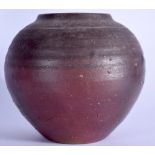 A GLOBULAR AMERICAN STUDIO POTTERY VASE, formed with a mottled brown glaze and incised banding. 20 c