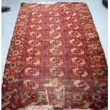 AN EARLY 20TH CENTURY RED GROUND TEKKE TURKMEN RUG, decorated with motifs. 190 cm x 126 cm.