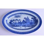 AN 18TH CENTURY CHINESE EXPORT BLUE AND WHITE DISH Qianlong, painted with a figure upon a spotted bu