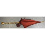 A 20TH CENTURY UMBRELLA, carved with foliage. 105 cm.