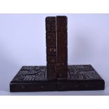 A PAIR OF SOUTH AMERICAN CARVED WOODEN BOOKENDS, depicting symbols and portraits. 20 cm high.