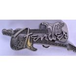 A WHITE METAL FENDER STRATOCASTER ELECTRIC GUITAR BELT BUCKLE. 13.2 cm wide.