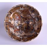 A LARGE UNUSUAL 19TH CENTURY JAPANESE MEIJI PERIOD SATSUMA BOWL with barbed rim, painted with figure