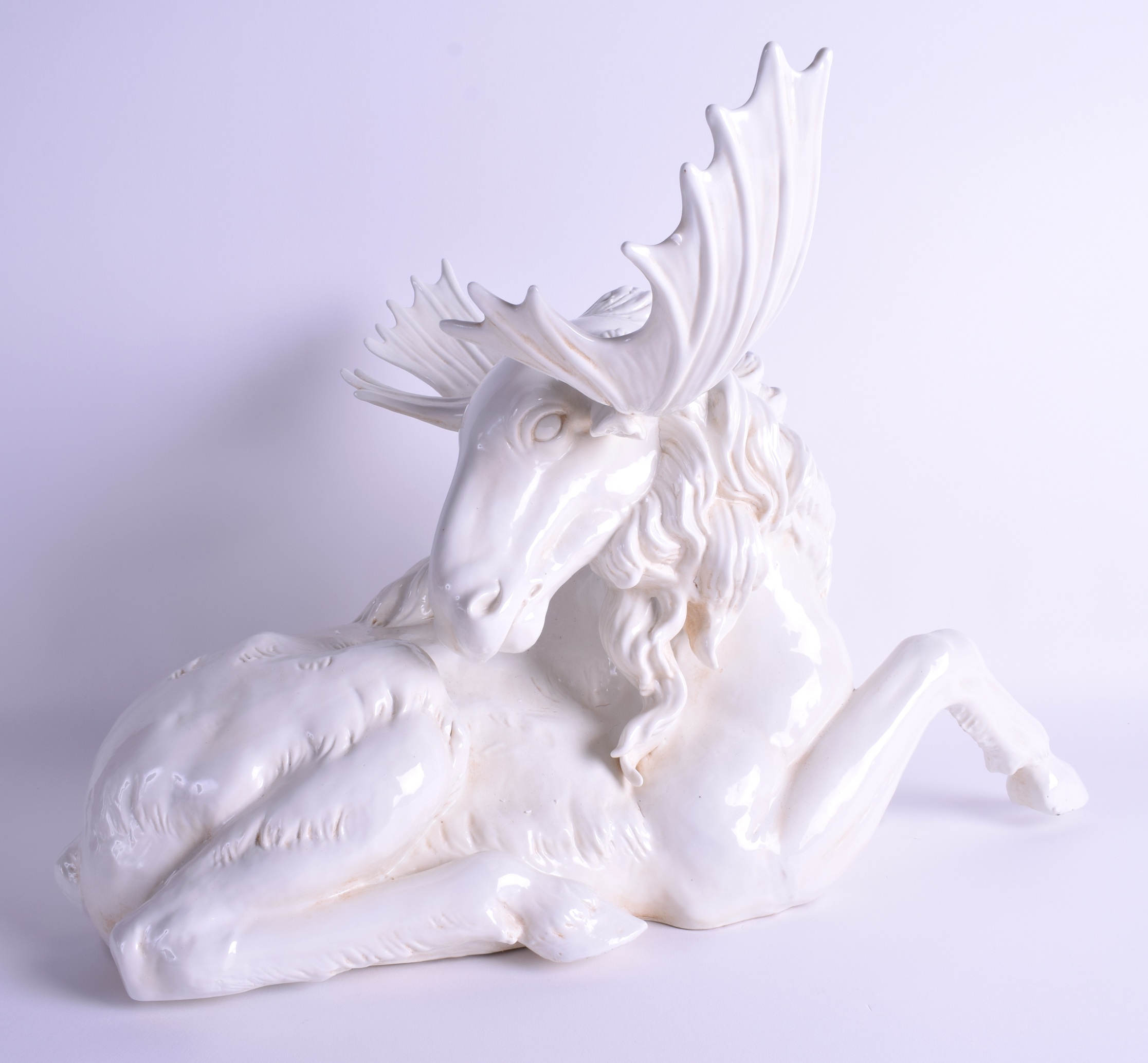 A LARGE CONTINENTAL PORCELAIN GROUP OF A RECUMBANT MOOSE modelled with its head turned. 52 cm x 37 c - Image 2 of 4