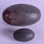 TWO 19TH CENTURY INDIAN CARVED STONE BUDDHISTIC PEBBLES. 11 cm & 5 cm long. (2)