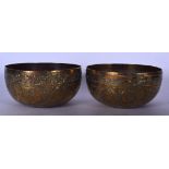 A PAIR OF 19TH CENTURY ISLAMIC BRASS BOWLS, engraved with birds amongst extensive foliage. 18.5 cm w