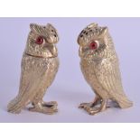 A PAIR OF EARLY 20TH CENTURY SILVER GILT PEPPER POTS modelled as owls. 7.5 cm high.