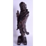 A 19TH CENTURY CHINESE CARVED HARDWOOD FIGURE OF A SCHOLAR modelled holding a peach. 36 cm high.