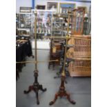 A PAIR OF VICTORIAN MAHOGANY POLESCREENS, formed with scrolling carved legs. 156 cm high.