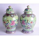 A GOOD PAIR OF 19TH CENTURY CHINESE FAMILLE ROSE VASES AND COVERS Jiaqing/Daoguang, painted with bir