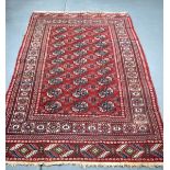 AN EARLY 20TH CENTURY TEKKE TURKMEN RUG, decorated with motifs. 190 cm x 126 cm.