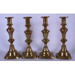 TWO PAIR OF EARLY 20TH CENTURY BRASS CANDLESTICK HOLDERS, formed on octagonal bases. 25 cm high.