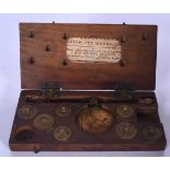 AN EARLY 20TH CENTURY FRENCH CASED SET OF SCALES, containing various weights. 14.5 cm wide.